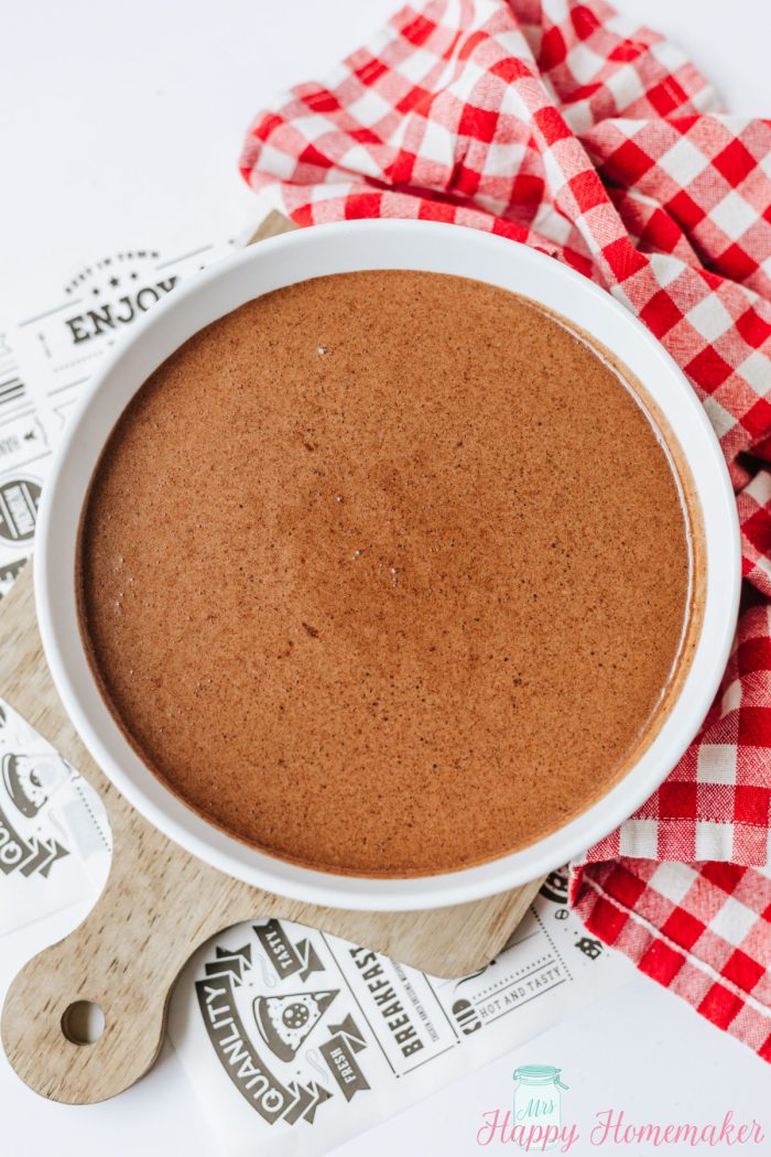 chocolate fudge pie batter in a white bowl ready to go into the pie crust