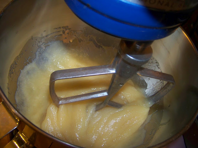 cake batter being mixed in a stand mixer 