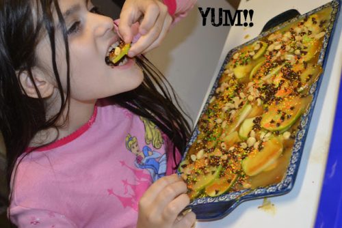 My daughter eating a plate of apple nachos
