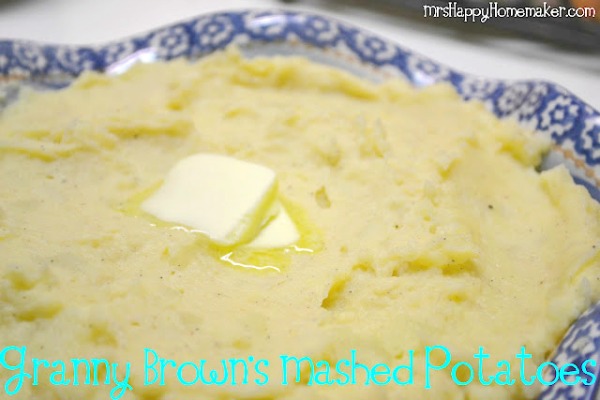 Granny Brown's mashed potatoes served in a blue ruffled bowl with a pat of melting butter on top