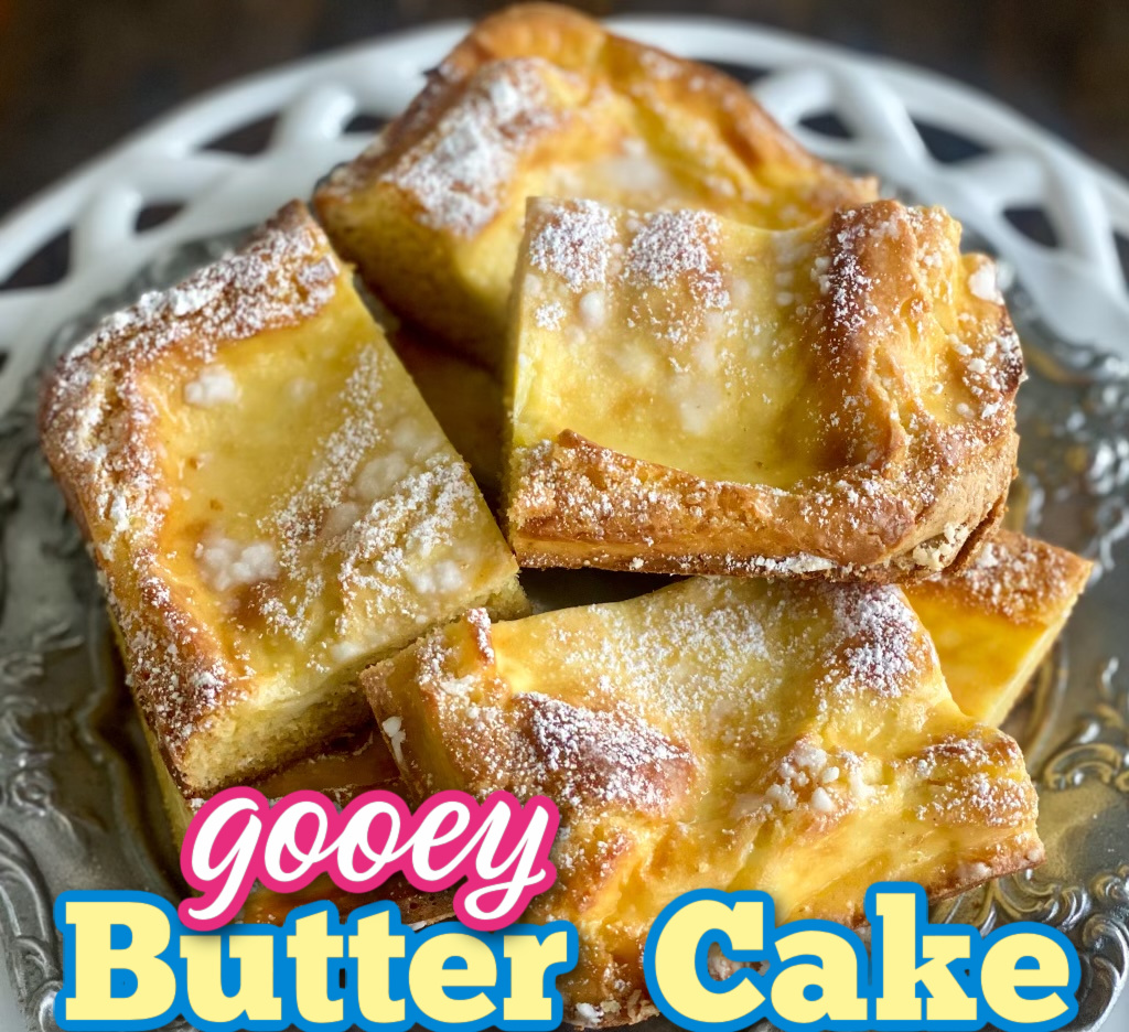 Closeup of Gooey butter cake, sliced into squares On a white plate