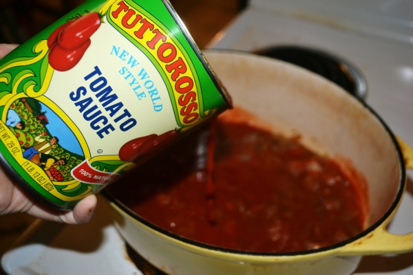 Pouring tomato sauce into a pot 