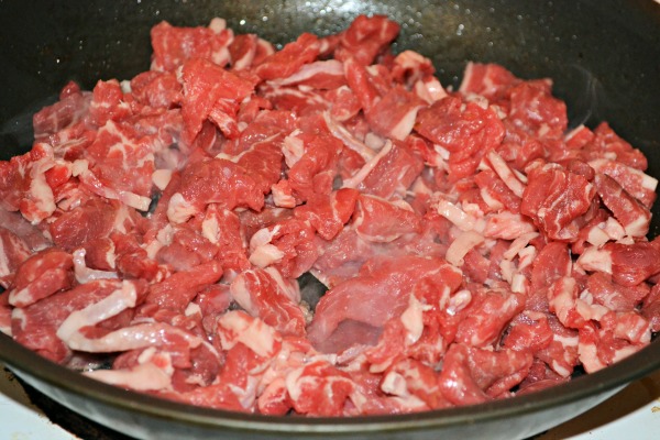Thinly sliced ribeye steak cooking in a skillet for My Favorite Philly Cheesesteak Sandwich