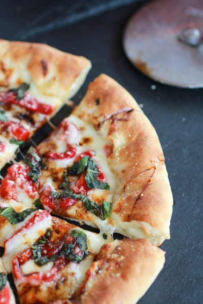 Green Olive Pesto Pizza with Feta Stuffed Crust, Roasted Red Peppers & Balsamic Drizzle