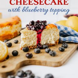 Lemon Cheesecake with blueberry topping on a wooden cutting board