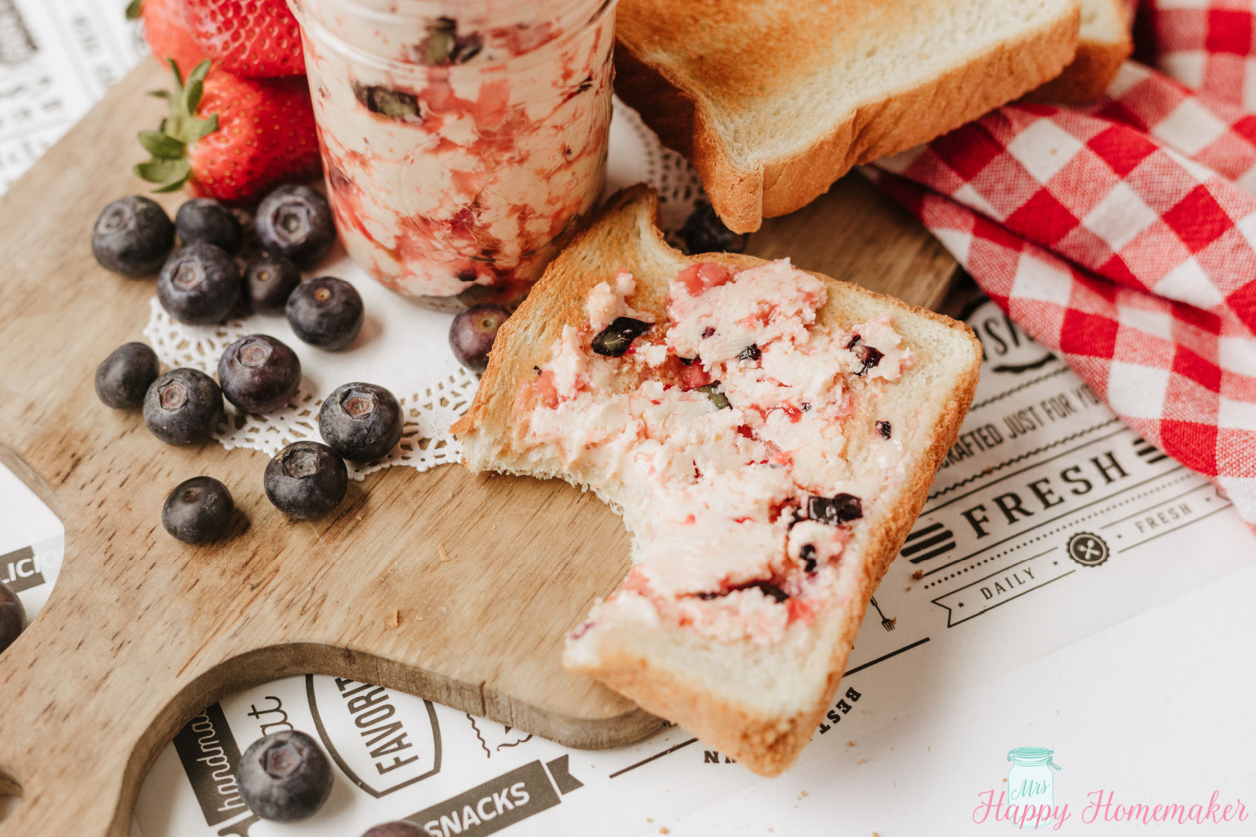 Berry Butter in a mason jar beside of berry butter spread on a piece of toast
