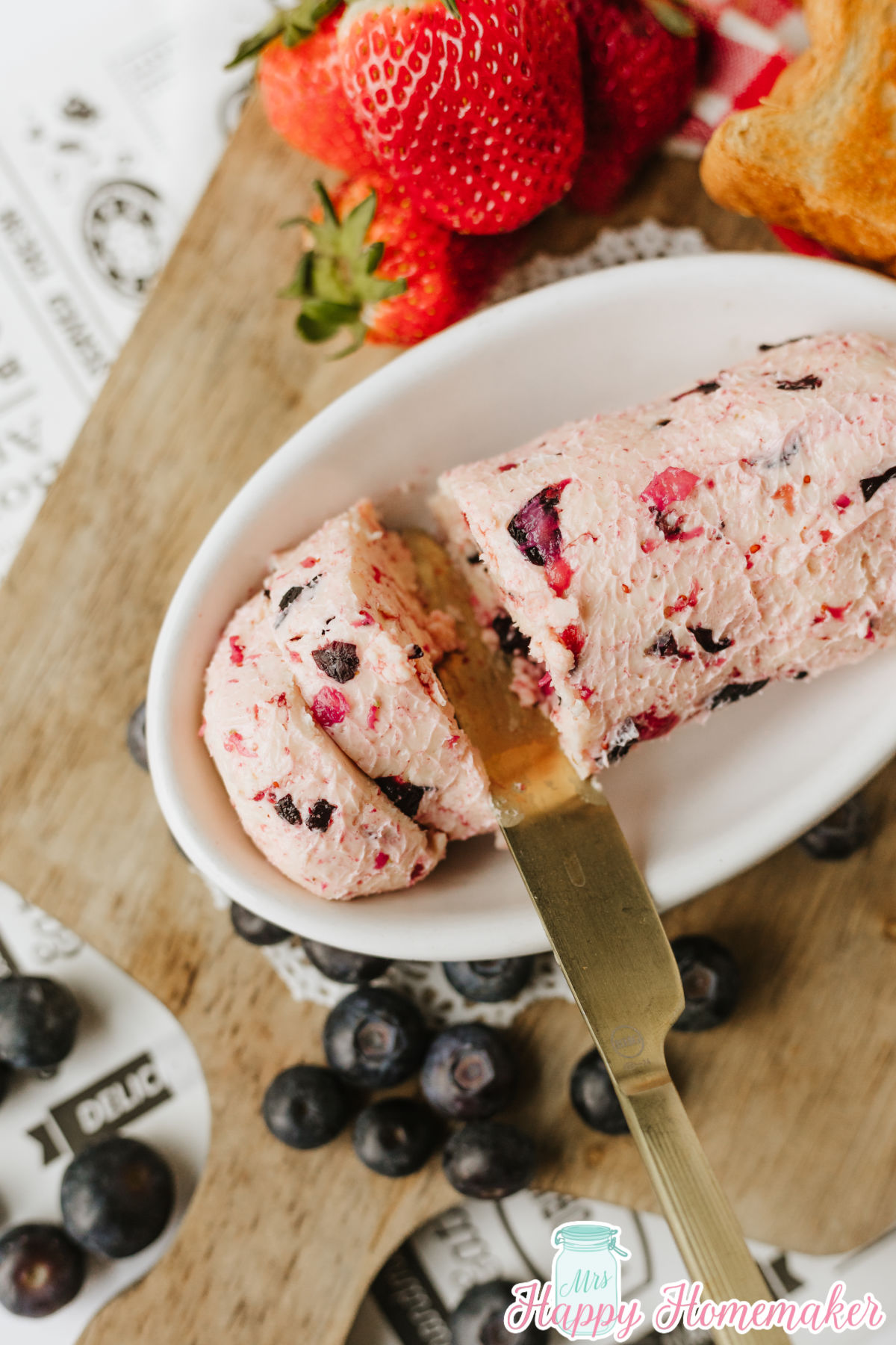Homemade 2 Ingredient Berry Butter in a white dish surrounded by berries