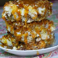 These Caramel Apple Crumble Cheesecake Bars are a combination of apple cobbler, caramel apples, & cheesecake - and they are out of this world delicious!