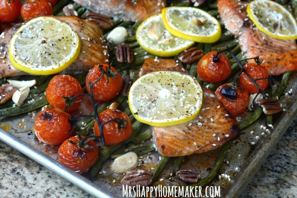 Ginger Teriyaki Salmon & Green Beans, with roasted tomatoes, lemon, garlic, & pecans, all cooked together in unity in this super simple one sheet pan meal! DELICIOUS! | Get the recipe at MrsHappyHomemaker.com