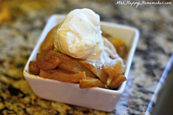 Crockpot Baked Apples in a white square dish topped with vanilla ice cream