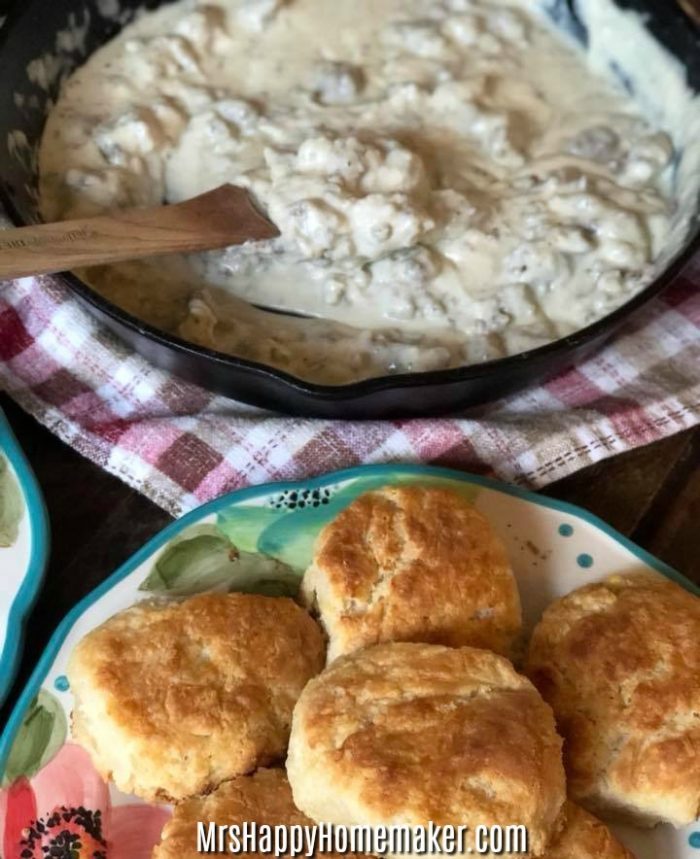 Sausage Gravy in a skillet & Buttermilk Biscuits on a plate