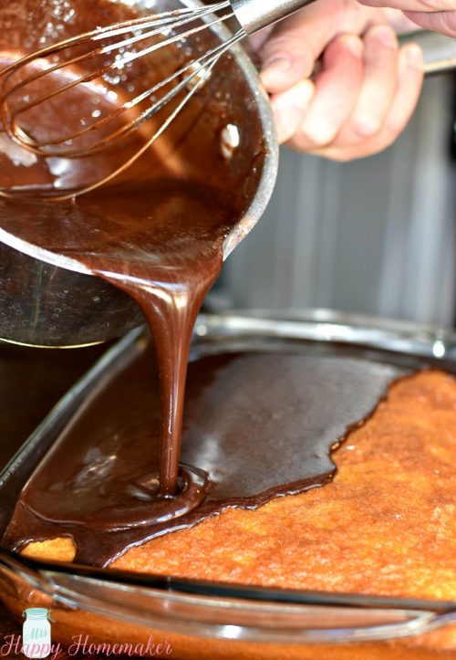 Chocolate being poured on Nannie's Hot Milk Cake | MrsHappyHomemaker.com