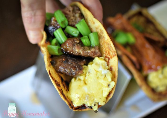 French Toast Tacos - flour tortillas dipped in French toast batter and cooked then stuffed with sausage or bacon and eggs with green onion garnish and a drizzle of pancake syrup 