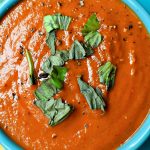 Roasted Tomato Soup with parsley garnish in a blue bowl