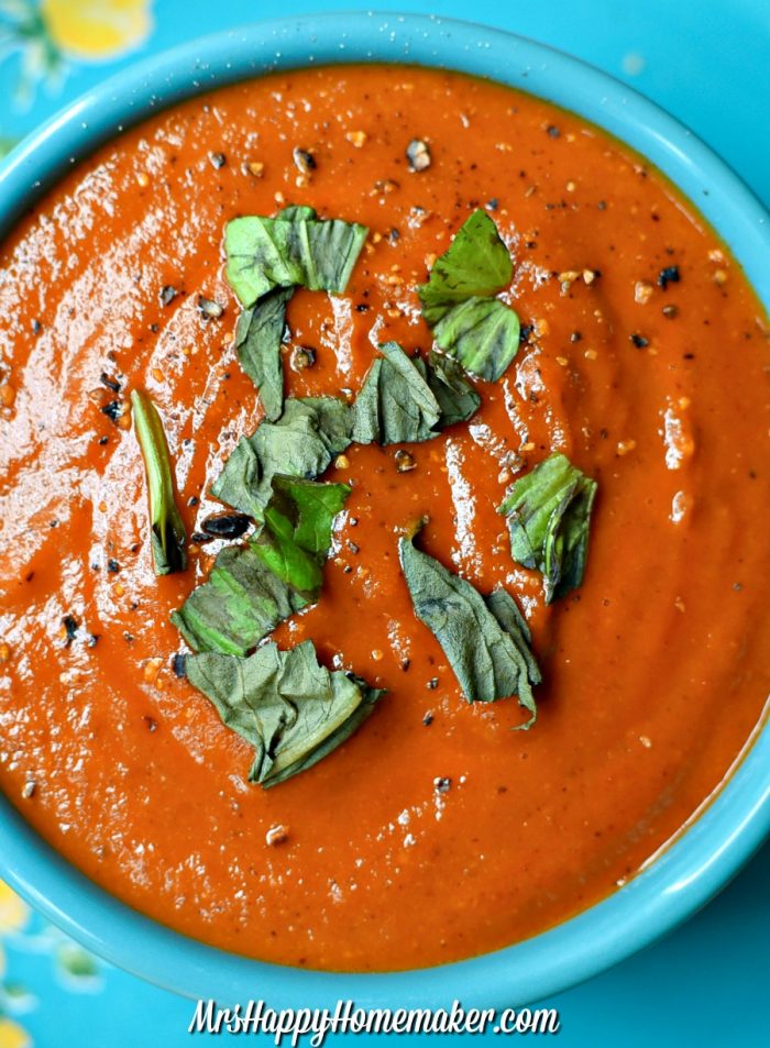 Roasted Tomato Soup with parsley garnish in a blue bowl 