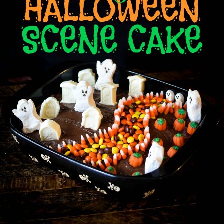 Halloween scene cake with candy ghosts, graves, pumpkins and a sidewalk