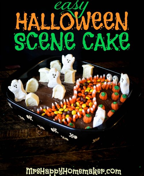 Halloween scene cake with candy ghosts, graves, pumpkins and a sidewalk