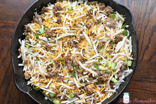 Sausage Hash Brown Breakfast Casserole before baking in a cast iron skillet | MrsHappyHomemaker.com
