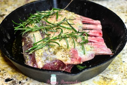 Easy Roasted Rack of Lamb in a cast iron skillet before it's cooked