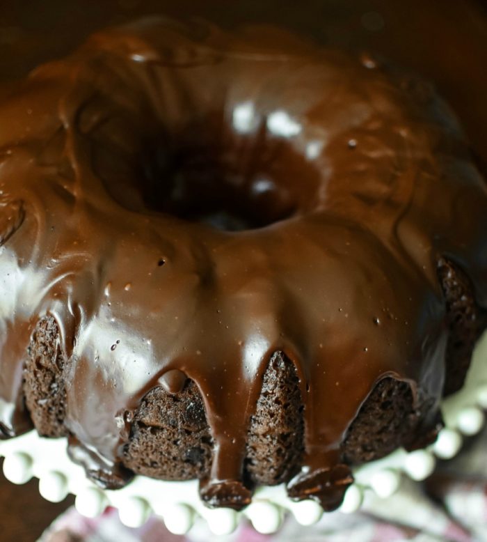 Chocolate Overboard Bundt Cake - the easiest, richest, most decadent (but still simple!) chocolate cake I have ever made... and it starts with a cake mix! Covered with chocolate ganache | MrsHappyHomemaker.com 