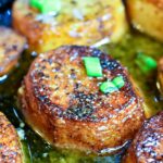Melting Potatoes - round potatoes cooked in butter in a cast iron skillet, garnished with green onions | MrsHappyHomemaker.com
