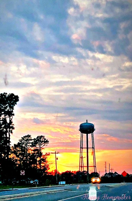 sunset with a water tower in the background