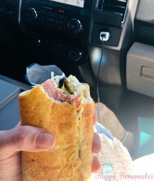 Publix sub being eaten on a road trip in the car