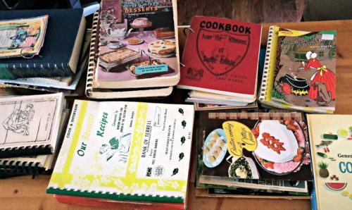 various vintage cookbooks on a tabletop