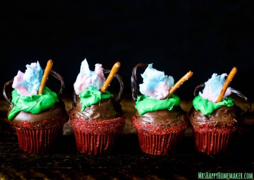 Cauldron Cupcakes with cotton candy flames, licorice handle, and pretzel stirrer