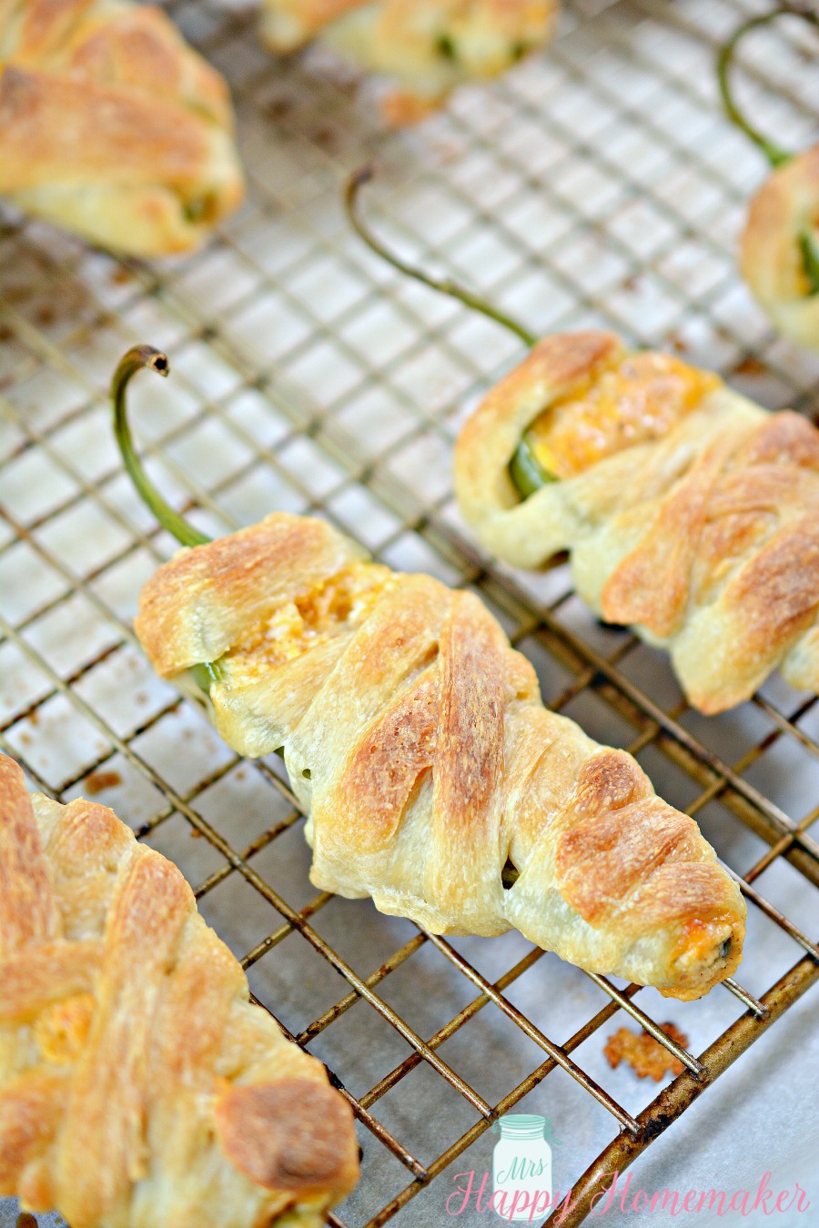 Jalapeno Popper Mummies - jalapeños stuffed with cheese and wrapped in refrigerated dough strips to resemble mummy wrappings. 