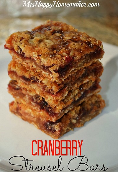 Cranberry streusel bars stacked up on a white plate