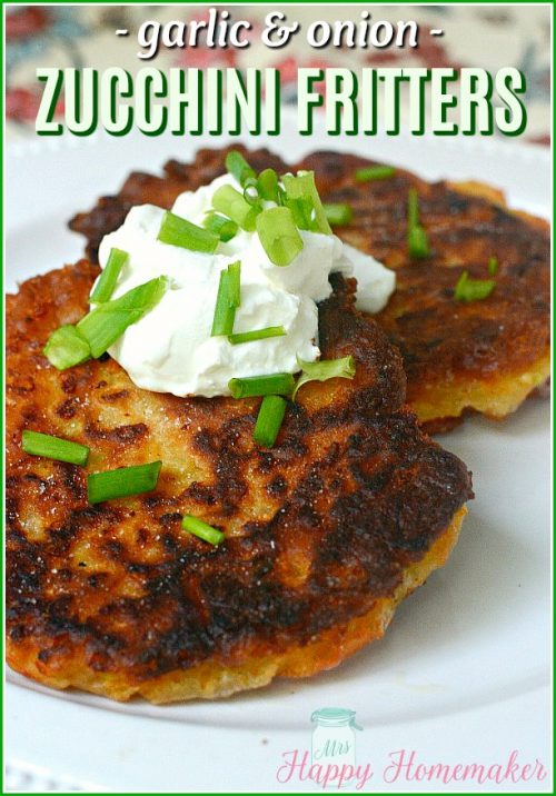 Garlic & Onion Zucchini Fritters topped with sour cream and chopped green onions