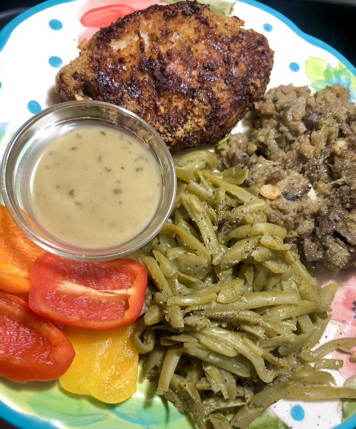 A dinner plate with air fried pork chops plus sides