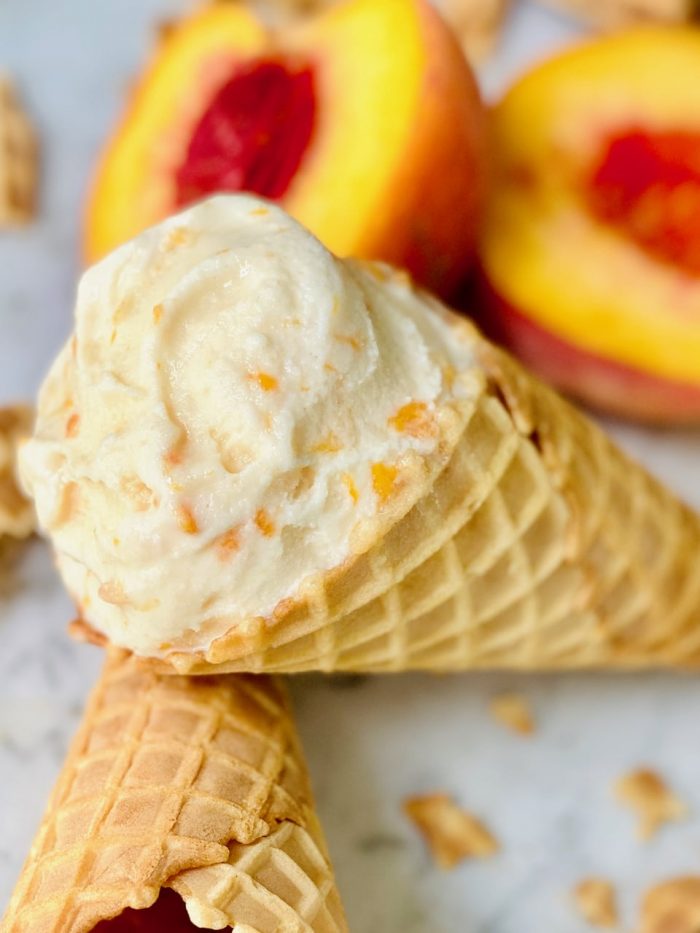 Homemade peach ice cream in an ice cream cone
