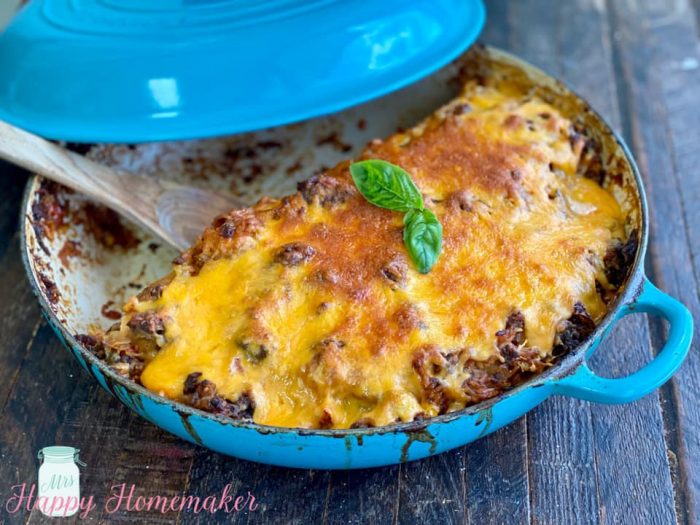 Stuffed Bell pepper casserole in a blue cast iron pan with a lid