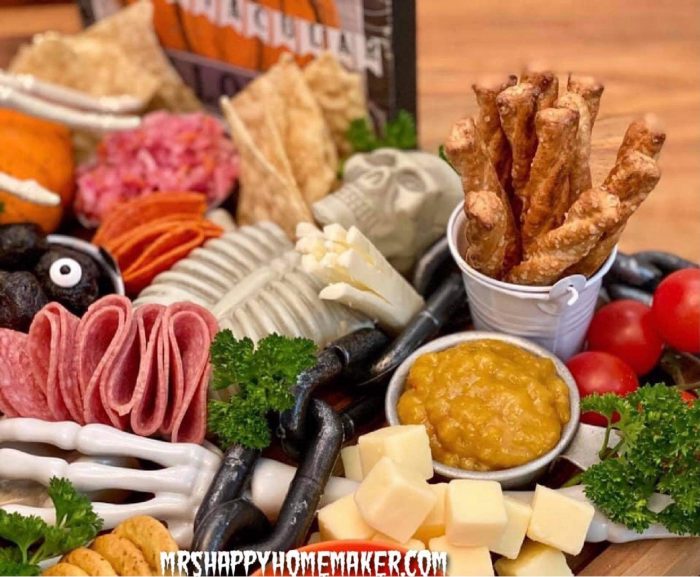 Halloween charcuterie board - skeleton surrounded by meats and cheeses 