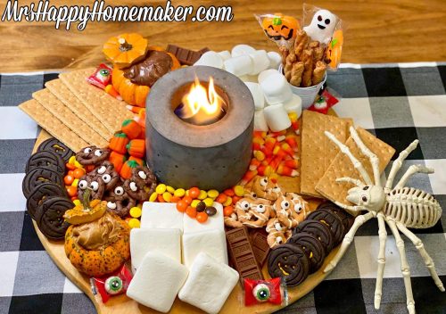 Halloween s’mores charcuterie board with an indoor fire pit in the center