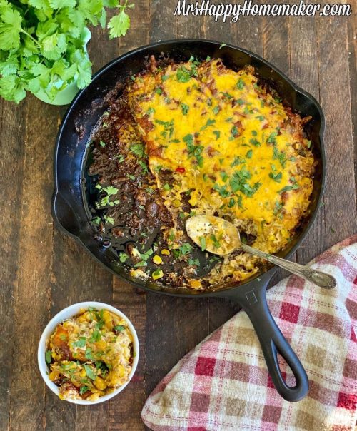 Cheesy sausage corn dip in a cast iron skillet