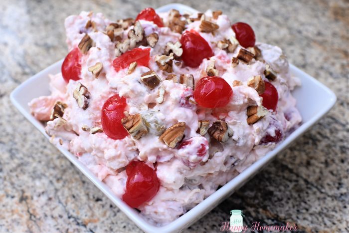 Cherry Cheesecake Fluff Salad in a square white bowl on a granite counter 