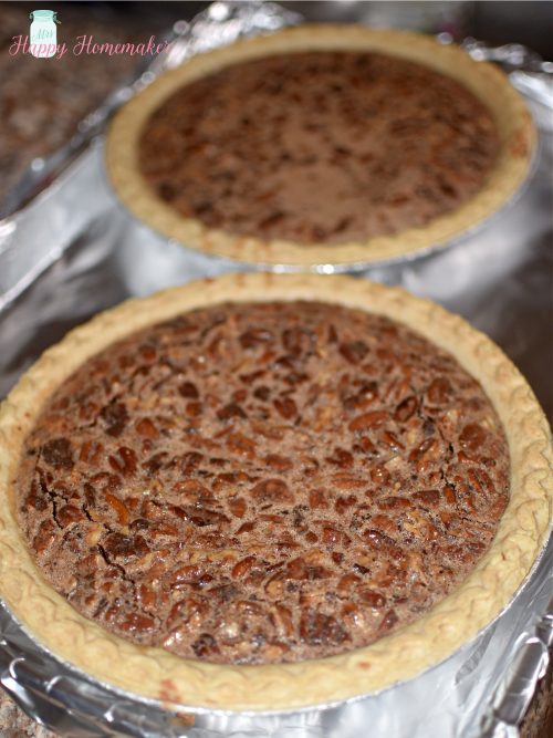 2 chocolate pecan pies on a tin foil lined baking sheet