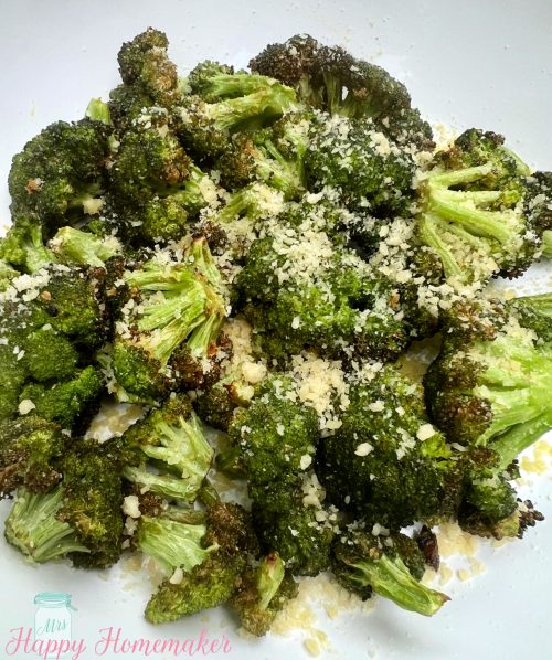 Air fryer broccoli in a white dish Sprinkled with cheese