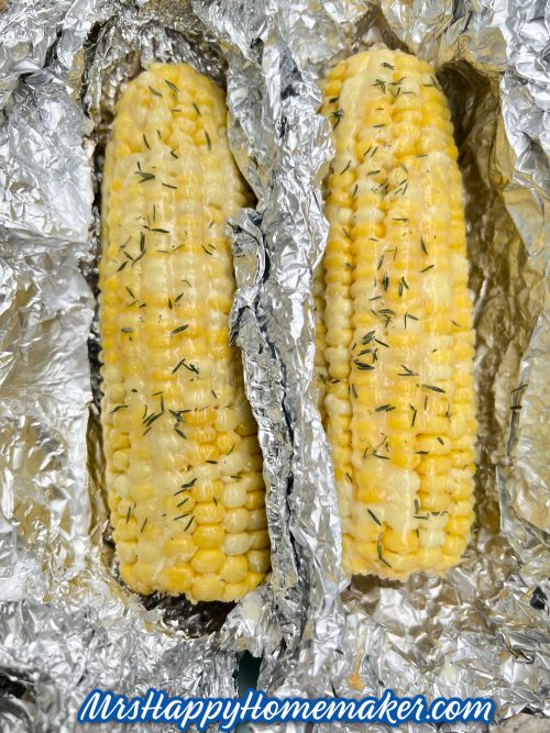 Two ears of corn inside of aluminum foil