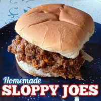 Homemade sloppy joes on a burger bun on a blue plate