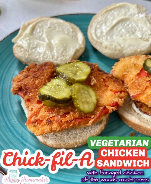 Vegetarian chick-fil-a chicken sandwich on a blue plate, topped with pickles and the top bun laying on the side of the bottom half of the sandwich