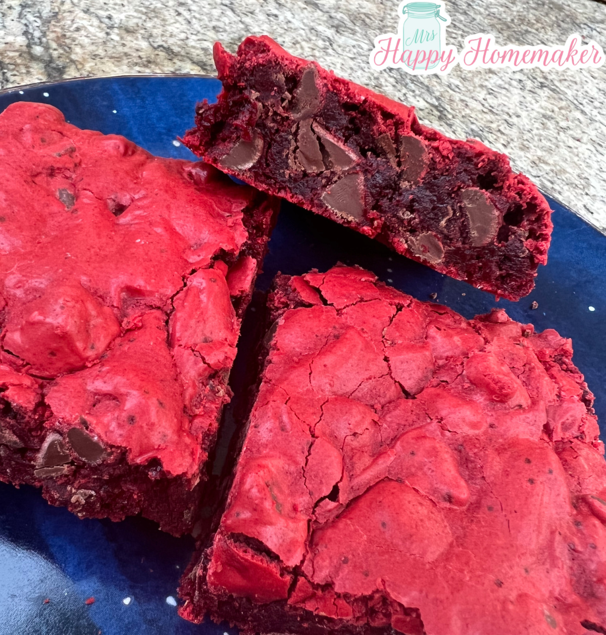 Three Red velvet cookie bars stacked up on a blue plate