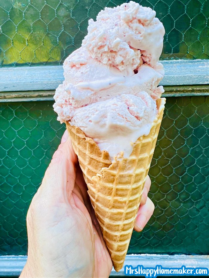 Strawberry ice cream scooped in an ice cream cone