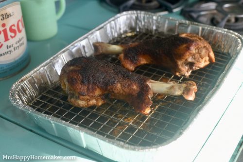 Roasted turkey legs on a wire rack in a baking sheet