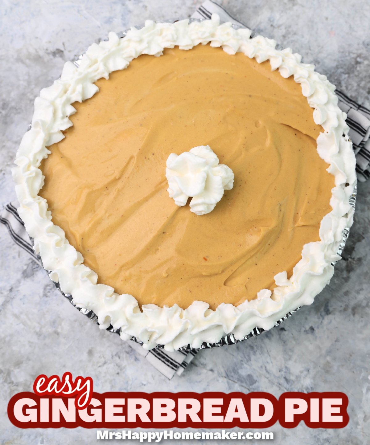Gingerbread pie, with a whipped cream border, on a marble counter 