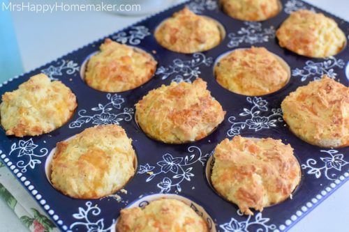 Cracked pepper cheddar muffins in a blue muffin pan