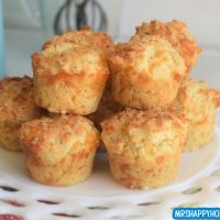 Cracked pepper cheddar muffins on a milk glass plate